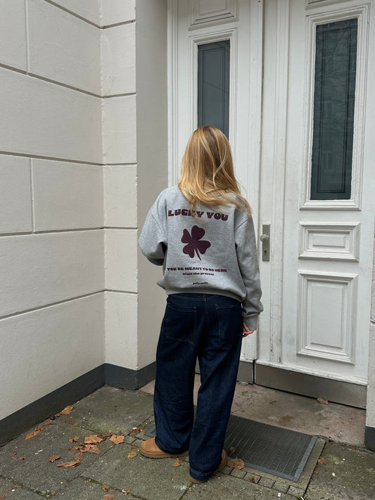 Girl wearing a grey sweatshirt