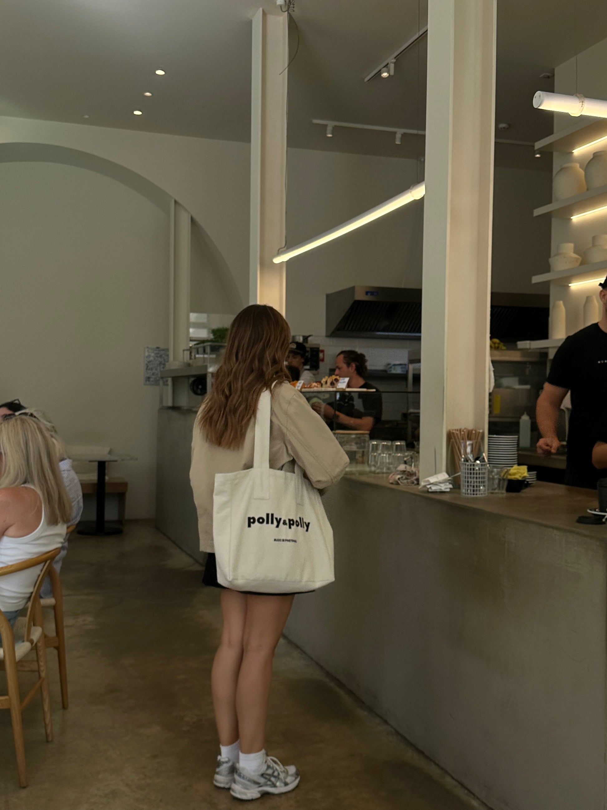 Women using a tote bag in a coffee shop