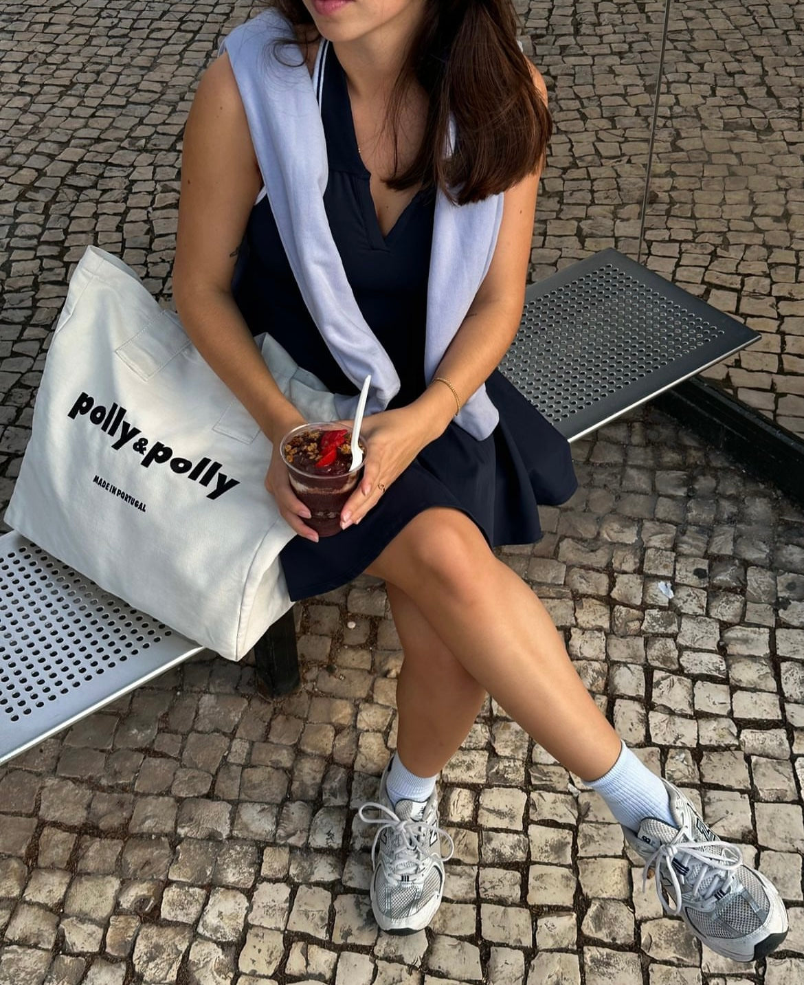 women using a tote bag in a bench